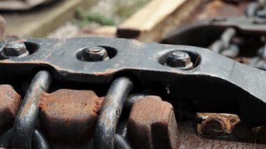 Bolt clutch of chain traction engineering industrial mechanism with rust closeup