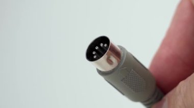 5-Pin stereo cable with DIN standard plug. Analog connector in hand close up