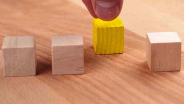 Hand Moves Vivid Yellow Wooden Block Stacking Geometric Wood Cubes — ストック動画