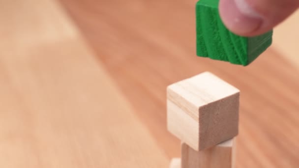 Hand Placing Green Toy Cube Top Tower Wooden Blocks Environmentally — Vídeos de Stock