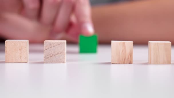 Hand Moves Green Wooden Block Stacking Geometric Wood Cubes Row — Stockvideo