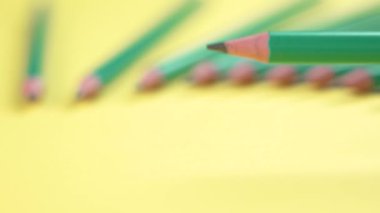 A set of graphite wooden pencils on a yellow background for sketching and drawing. School supplies art creative concept