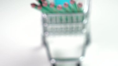 A group of graphite pencils in a mini shopping cart on a white background. Consumerism and back to school idea. Office supply miniature