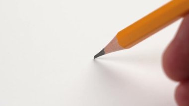 Breaking pencil lead due to stress and anger on white office paper close-up