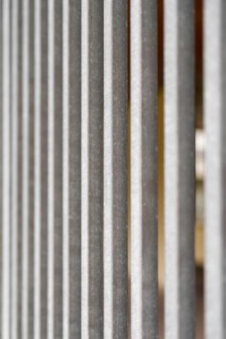Parallel vertical geometric lines of a galvanized house yard fence lattice. Abstract view