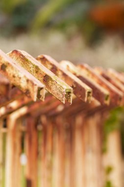 Old rusty metal fence with corroded texture close up