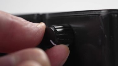 Yerel bir elektrikli aletin siyah düğmesini yakın çekimle çevirerek gücün ayarlanması ve düzenlenmesi. Enerji verimliliği kavramı