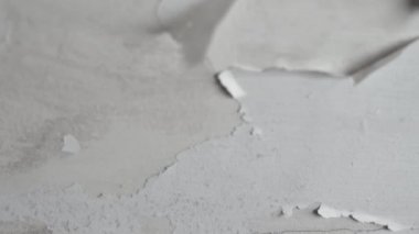 Banyonun tavanında beyaz boya tabakası çatlamış. Yüksek nem ve su sızıntısından sonra hasarlı alçıpan