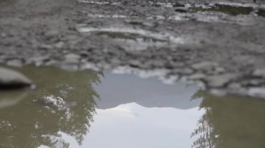Su birikintilerinde yürüyen ayak izleri.