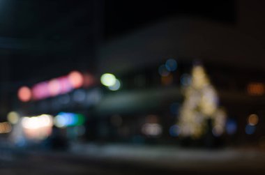 defocused night shot of bokeh lights at street