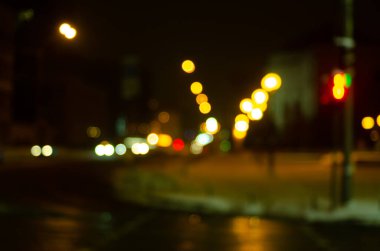 defocused night shot of bokeh lights at street