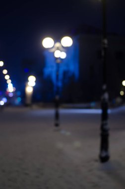 defocused night shot of bokeh lights at street