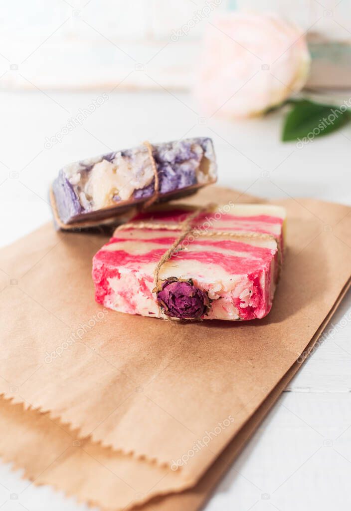 Handmade natural soap with rose and lavender on wooden, paper background