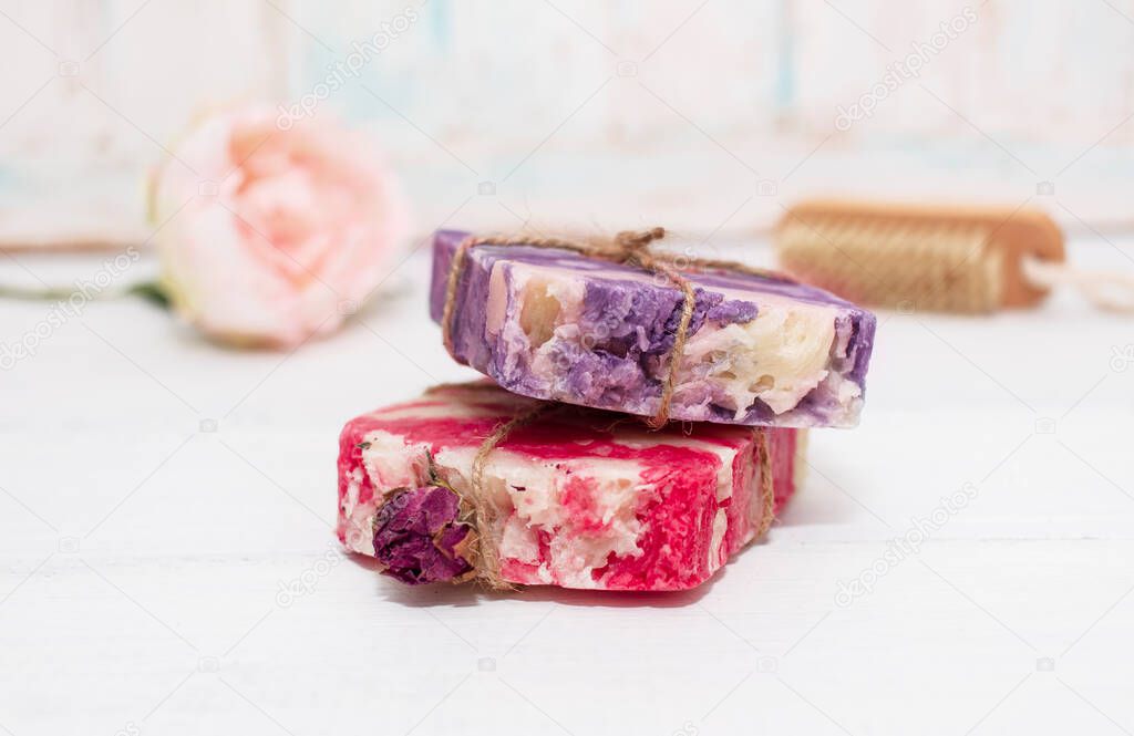 Handmade natural soap with rose and lavender on wooden background