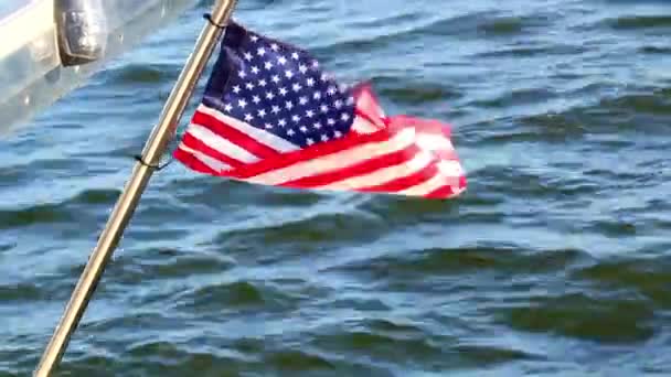 在蓝水背景的游艇上，美国国旗在风中飘扬 — 图库视频影像