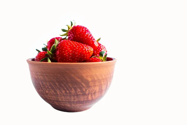 Fresh strawberries in a brown bowl on white background — ストック写真