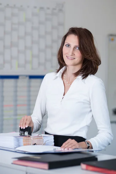 Office clerk stamps documents — Stock Photo, Image