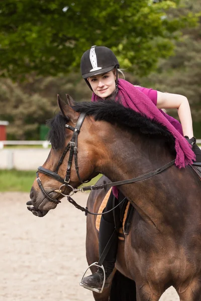 Girl sits on her pony — Stock Photo, Image