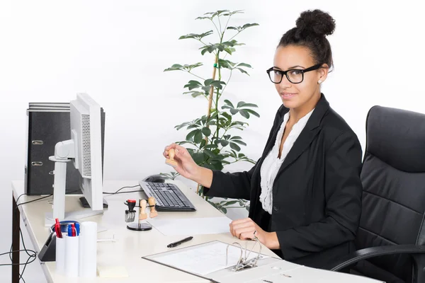 Business woman holds a stamp — Stock Photo, Image