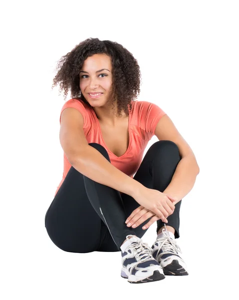 Young sportswoman sits on the ground — Stock Photo, Image