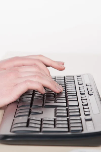 Woman types on the keyboard Royalty Free Stock Photos