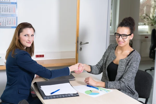 Due donne che fanno una stretta di mano durante una riunione — Foto Stock