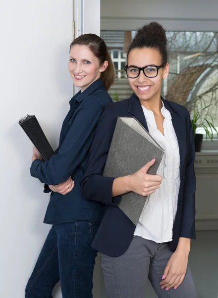 Two women with files Royalty Free Stock Photos