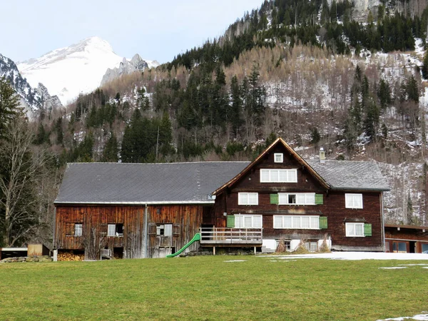 早春の伝統的なスイスの建築と木造の高山の家と周囲の牧草地に雪の残骸と ワイルドハウス オーバートッゲンブルク スイス スイス — ストック写真