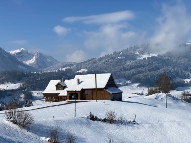 İsviçre çayırlarındaki yerli dağ kulübeleri ve ahşap ahırlar taze beyaz kar örtüsüyle kaplıdır, Nesslau - Obertoggenburg, İsviçre (Schweiz)