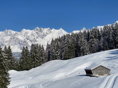 İsviçre çayırlarındaki yerli dağ kulübeleri ve ahşap ahırlar taze beyaz kar örtüsüyle kaplıdır, Nesslau - Obertoggenburg, İsviçre (Schweiz)