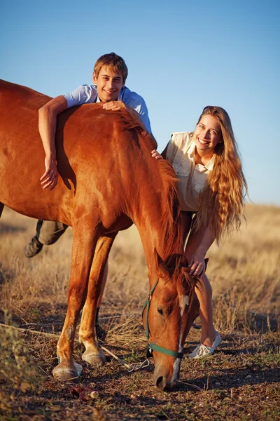 Brother and sister on a field — Stock Photo, Image