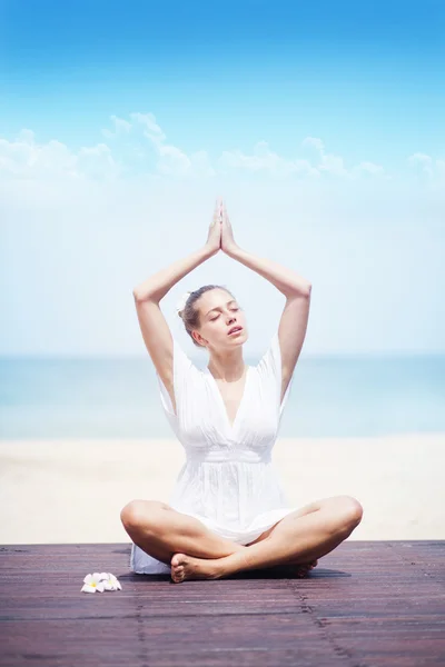 Porträt einer jungen Frau, die Yoga am Strand praktiziert — Stockfoto