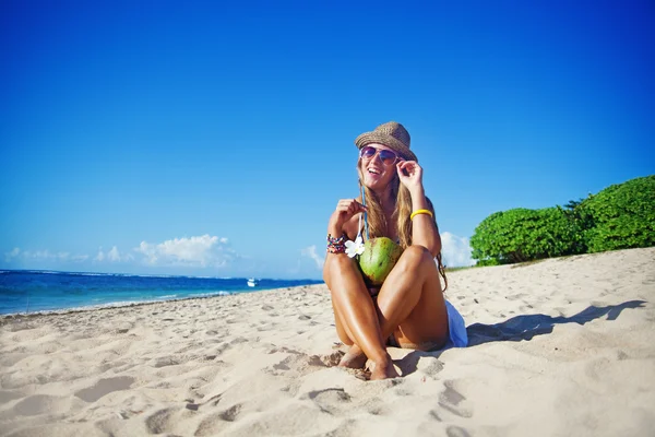 Mooie vrouw met kokos op het strand — Stockfoto