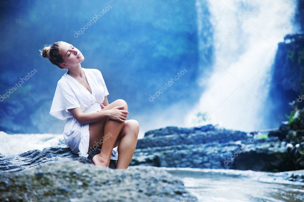 Young woman near waterfall, bali, indonesia