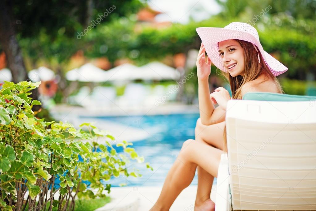 Young beautiful woman outdoors near swimming pool