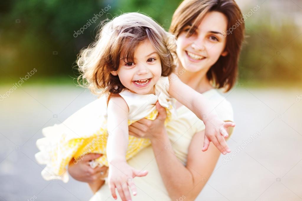 Young mother with child outside on a summer day