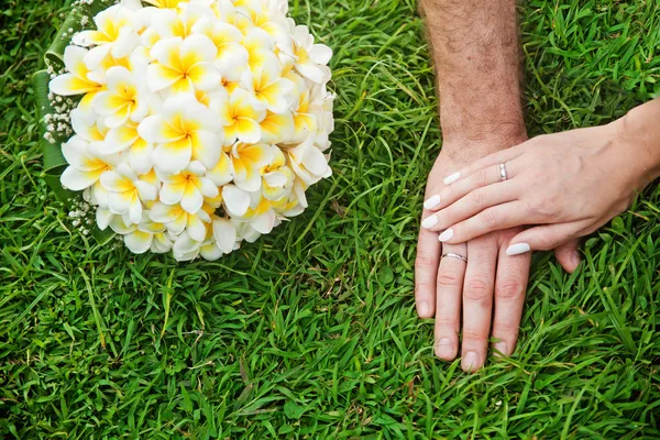 Hands and flowers on wedding day Stock Photo