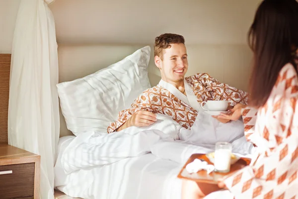 Wife waking up her husband with breakfast — Stock Photo, Image