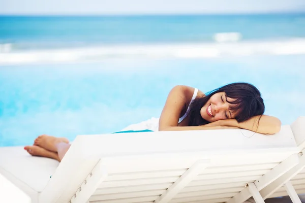 Mujer relajándose en el resort en una tumbona — Foto de Stock