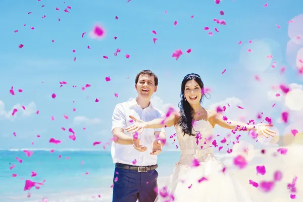 Wedding day - couple with plenty of petals — Stock Photo, Image