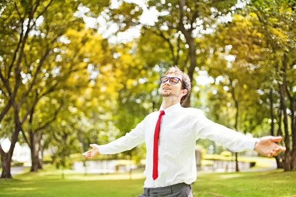 Businessman refreshing in autumn park or forest — Stock Photo, Image