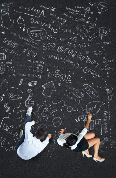 Business plan concept: woman and man writing plan of project on a floor — Stock Photo, Image