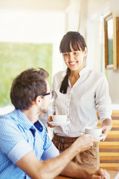 Situation in office - woman sharing tea with man — Stock Photo, Image