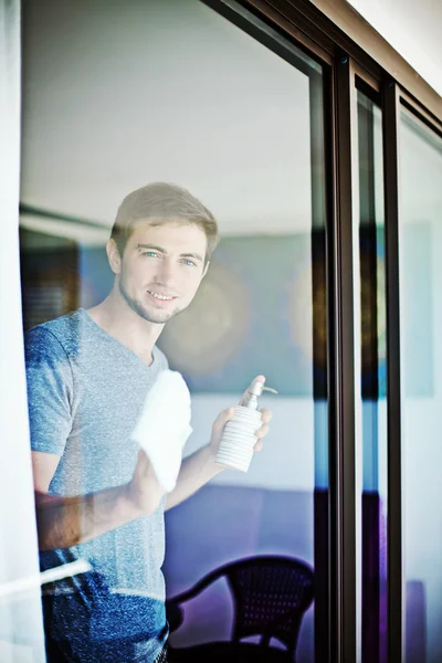 Man cleaning window at home — Stock Photo, Image