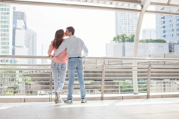 Couple kissing on modern bridge — Stock Photo, Image