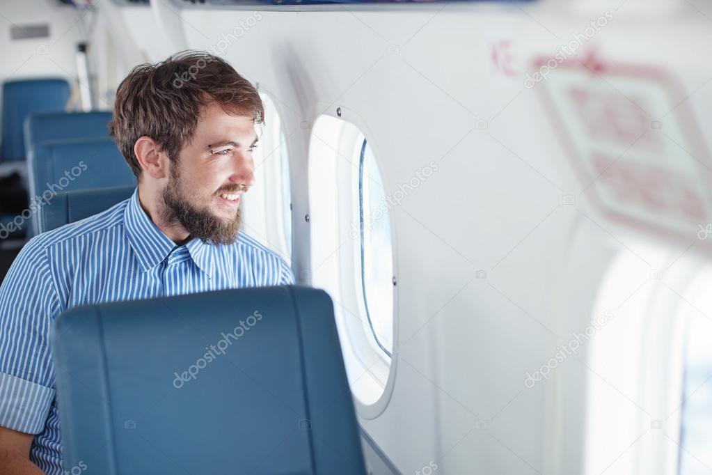 Man enjoying his journey in airplane