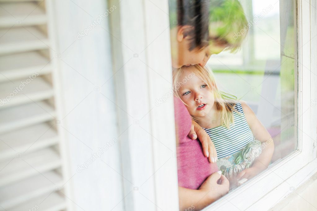Mother and daughter by the window