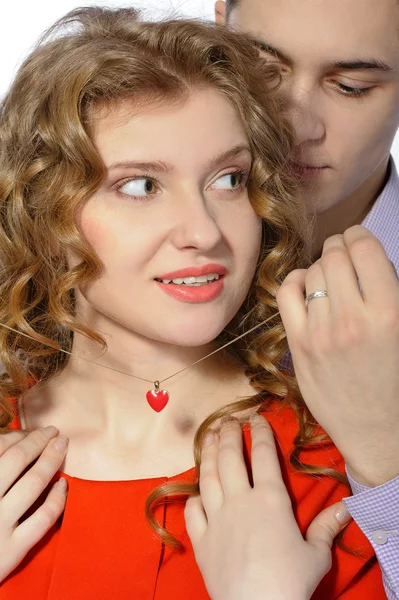 Young man gives his girlfriend a pendant — Stock Photo, Image