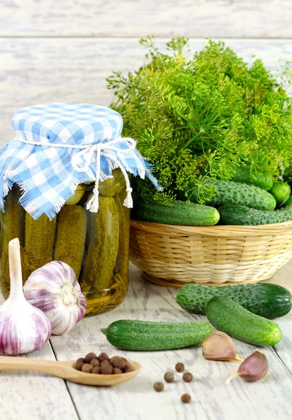 Konserverad gurka, färsk gurka och kryddor på ett träbord. h — Stockfoto