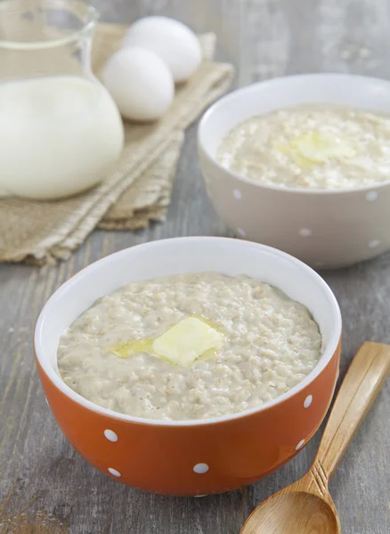 Oatmeal porridge with butter, milk and eggs — Stock Photo, Image